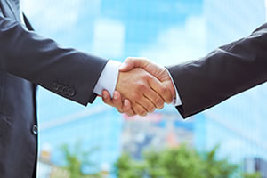 Business men in suits shaking hands